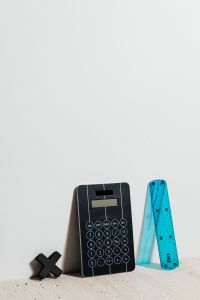 Kaboompics - Black Calculator and Single Blue Ruler on White for Simple Classroom and Math Graphics