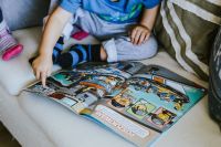 Kaboompics - Child reading a comic story
