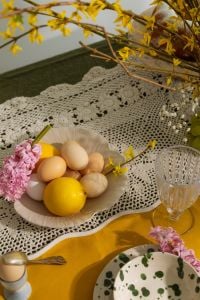 Kaboompics - Easter Eggs and Lemon in White Bowl with Hyacinths and Forsythia