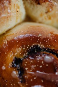 Kaboompics - Vertical Cinnamon Roll Swirl with Sugar and Icing for Pastry Branding