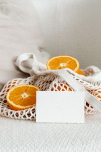 Kaboompics - Vertical Orange Product Mockup with Blank Card and Generous Linen Copy Space