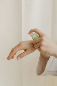 Kaboompics - Spraying Moisturizer onto the Back of a Hand from a Pump Bottle