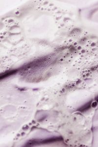 Kaboompics - Pale Lavender Skincare Foam with Fine Bubbles and Diagonal Cream Strokes