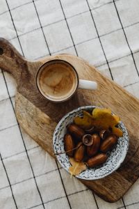 Kaboompics - Overhead Coffee Cup and Bowl of Acorns on a Wooden Board