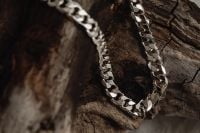 Kaboompics - Chunky Silver Curb Chain Necklace on Rustic Wood