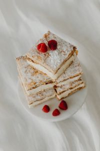 Kaboompics - Powdered Napoleonka Slices with Fresh Raspberries on a Dessert Plate