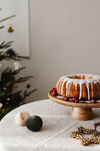 Kaboompics - Iced Bundt Cake on Wooden Stand with Christmas Tree