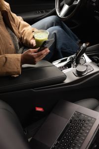 Kaboompics - Woman Holding Matcha While Working on a Laptop in a Car