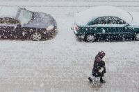 Kaboompics - Snowy Street with Cars & woman walking along a sidewalk