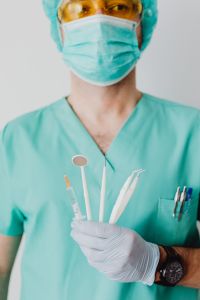 Kaboompics - Dentist Holding Assorted Dental Instruments Upright