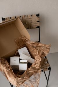 Kaboompics - Unboxing Beauty Products in a UGC Aesthetic: Elegant Skincare Packaging with Textured Wrapping
