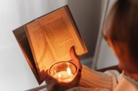 Kaboompics - Close-Up of Candlelit Reading Under a Blanket
