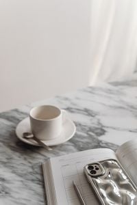 Kaboompics - Vertical Home Office Still Life with Coffee Cup, Planner and Silver Smartphone on Marble