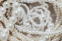 Kaboompics - Wide Close-Up of White Pearl Necklace Loops and Oversized Beads, Neutral Flat Lay Background