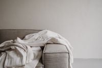 Kaboompics - White Linen Draped Over Neutral Sofa – Fujifilm X100VI Sample Photo
