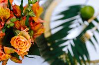 Kaboompics - Orange Rose and Alstroemeria Bouquet with Tropical Leaves, Styled Table