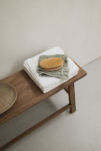 Kaboompics - Wooden Bench with Folded Towels and Body Brush