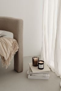 Kaboompics - Beige Armchair with Fringed Throw and Candles by Sheer Curtains