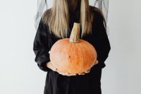 Kaboompics - Woman in Witch Costume Holding an Orange Pumpkin