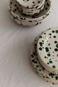 Kaboompics - Green Splatter Plate Stacks with Neutral Linen Copy Space
