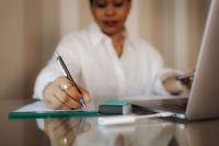 Kaboompics - Black Woman Handwriting Notes at Home Workspace