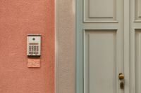 Kaboompics - Sage Green Door with Brass Handle and Doorbell on Pink Wall, Italy