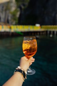 Kaboompics - Aperol Spritz beside Green Pier Rail over Seawater