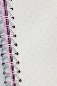 Kaboompics - Pink Spiral Notebook Edge on Graph Paper