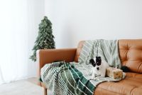 Kaboompics - Decorated Christmas Tree Beside Sofa With Dog Peeking Out