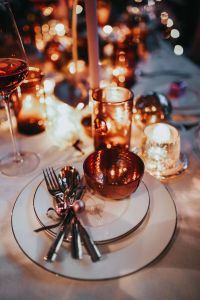 Kaboompics - Wine Glass and Candlelight among Copper Christmas Decor