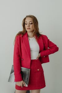 Kaboompics - Woman Holding a Fashion Magazine in a Fuchsia Skirt Suit