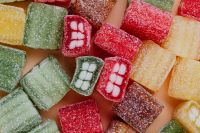 Kaboompics - Sugar-Coated Gummy Teeth and Colorful Square Candy, Playful Sweets