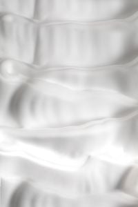 Kaboompics - Smooth White Skincare Cream Folded into Wide Horizontal Waves, Minimal Macro Background