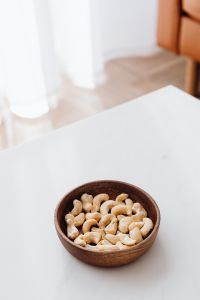 Kaboompics - Cashew Bowl on a White Coffee Table in a Sunlit Neutral Living Room