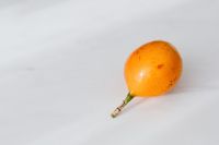Kaboompics - Whole Orange Passion Fruit on White Marble for Tropical Food Editorials and Social Posts