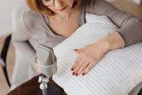 Kaboompics - Woman Resting Beside a Microphone with Hand on Ribbed Pillow, Relaxing ASMR