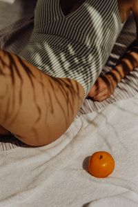 Kaboompics - Sunlit Poolside Relaxation with Striped Towel and Citrus