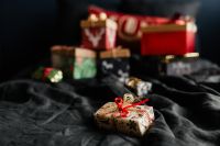 Kaboompics - Christmas Gift Wrapping with Red and Gold Ribbons