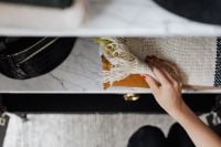 Kaboompics - Woman putting clothes on shelf