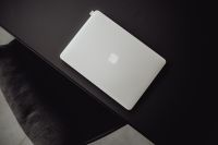 Kaboompics - Closed Silver MacBook on a Minimal Black Studio Desk