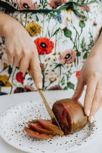 Kaboompics - Woman Slicing Fresh Produce with a Kitchen Knife