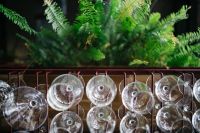 Kaboompics - A big bunch of wine glasses hanging from a holder
