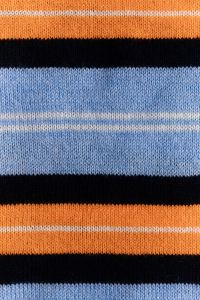 Kaboompics - Retro Striped Knit Texture – Orange Blue and Black Sweater