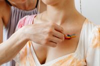 Kaboompics - Hand Painting a Rainbow Stripe Across Bare Chest