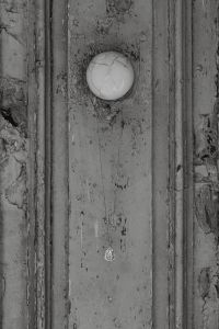 Kaboompics - Black and White Pendant Necklace on a Weathered Wooden Door, Monochrome Jewelry Photo