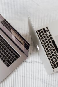 Kaboompics - Close-Up of Two Silver Laptops on White Textured Surface