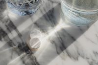 Kaboompics - White Tablets in Sunlit Marble Still Life