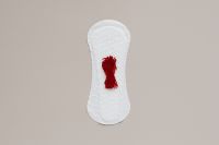 Kaboompics - Horizontal Sanitary Pad with Red Fabric Accent for Menstrual Health