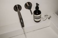 Kaboompics - Aesthetic Bathroom Sink Ledge with Soap and Beauty Products