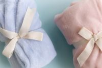 Kaboompics - Pastel Blankets Tied With Ribbon On Light Blue Background